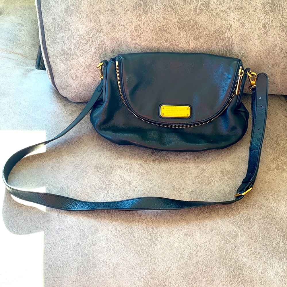 Black leather crossbody purse with gold accents